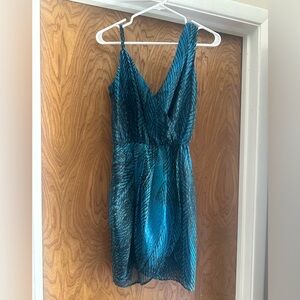 Fun and sexy faux wrap dress in a teal blue print dress